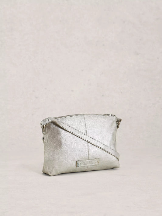 Silver crossbody bag on a light grey background