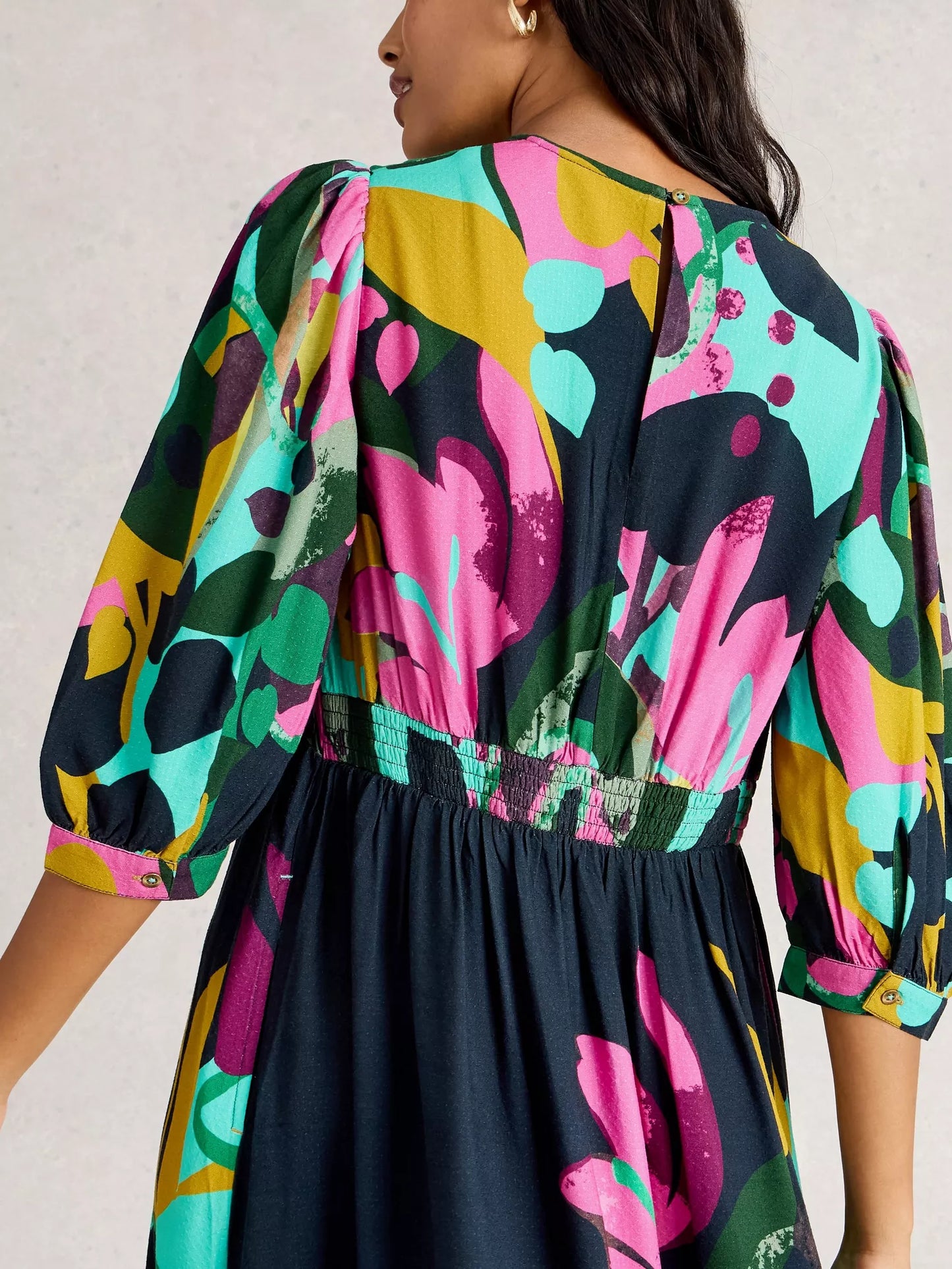 Colorful patterned dress with a plain background