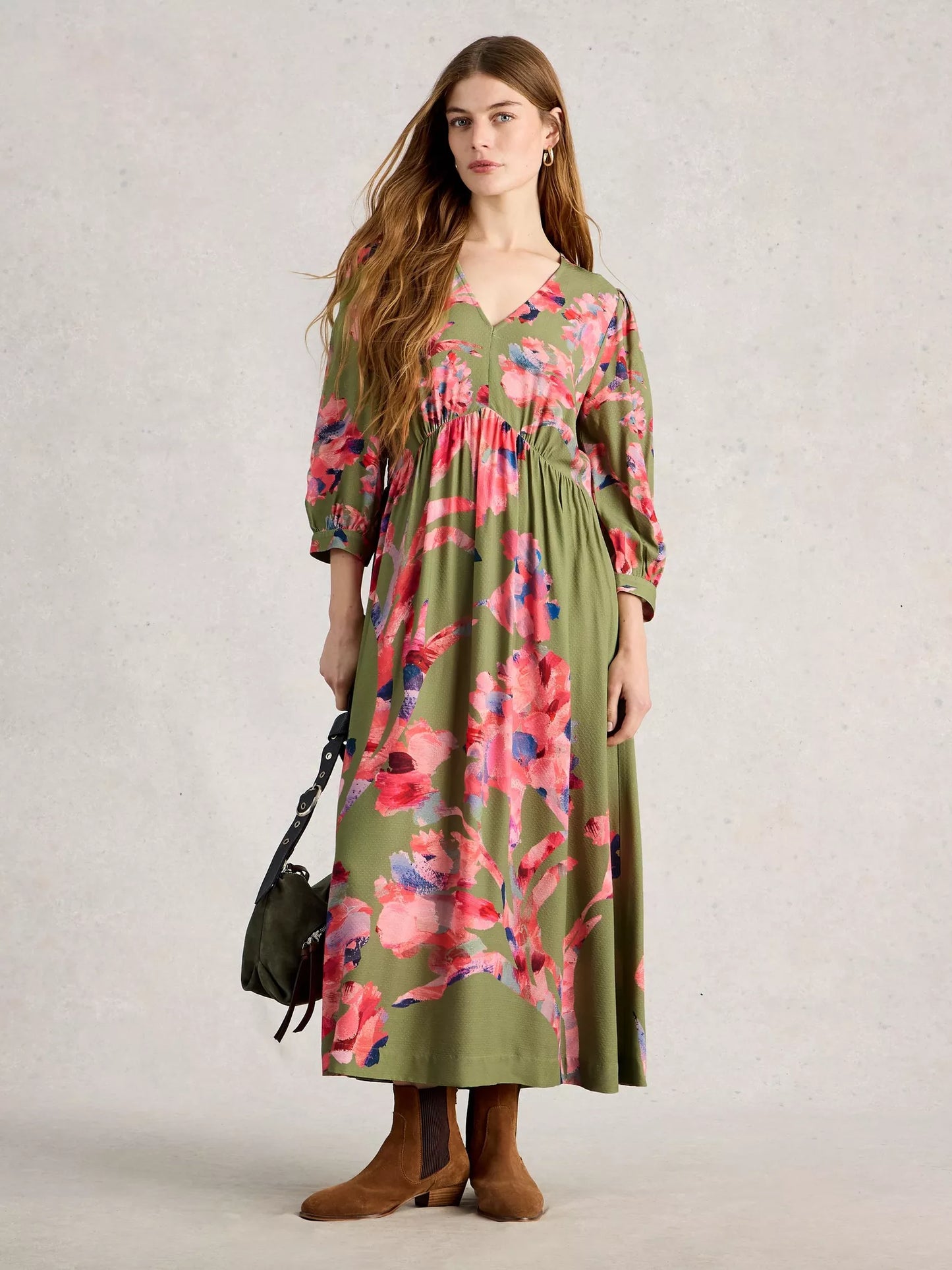 Woman wearing a floral dress with a plain background