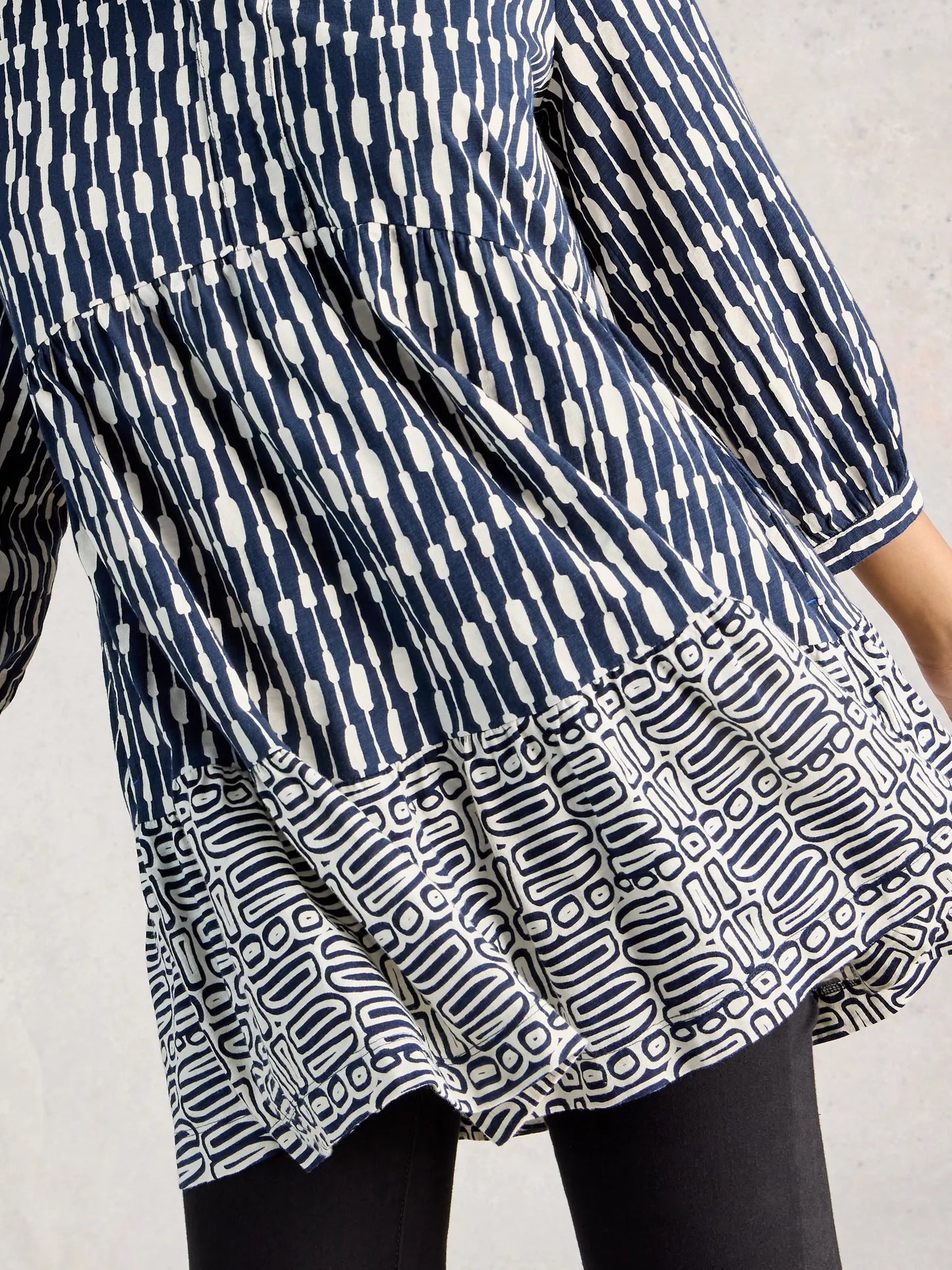Blue and white patterned dress on a plain background