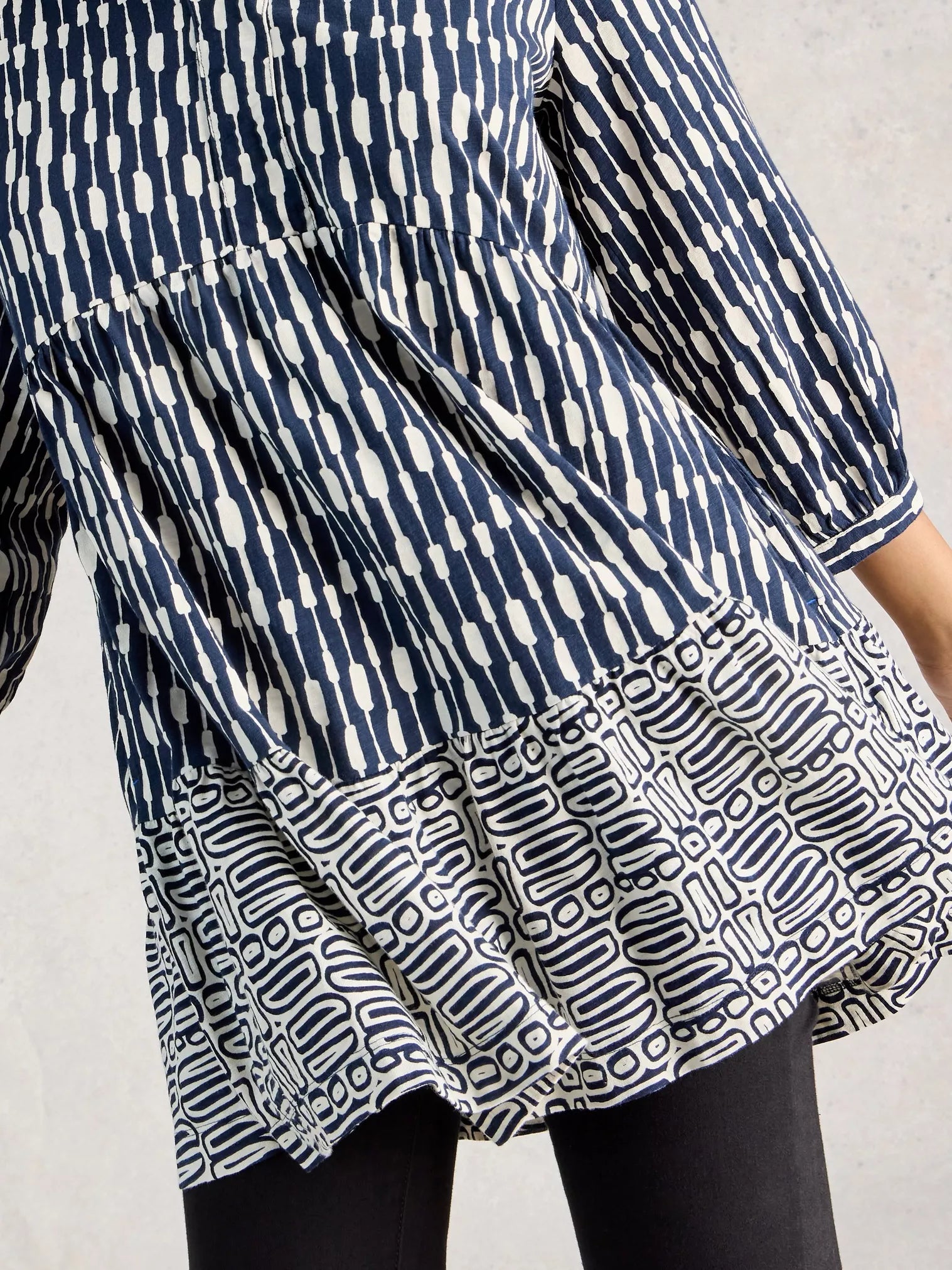 Blue and white patterned dress on a plain background