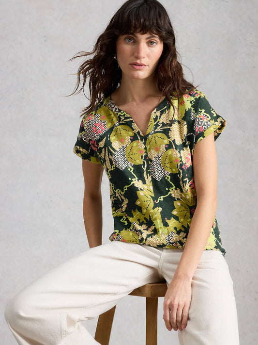 Woman wearing a floral blouse with a plain background