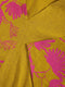 Close-up of yellow fabric with pink floral patterns