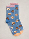 Blue socks with dog pattern on a light gray background