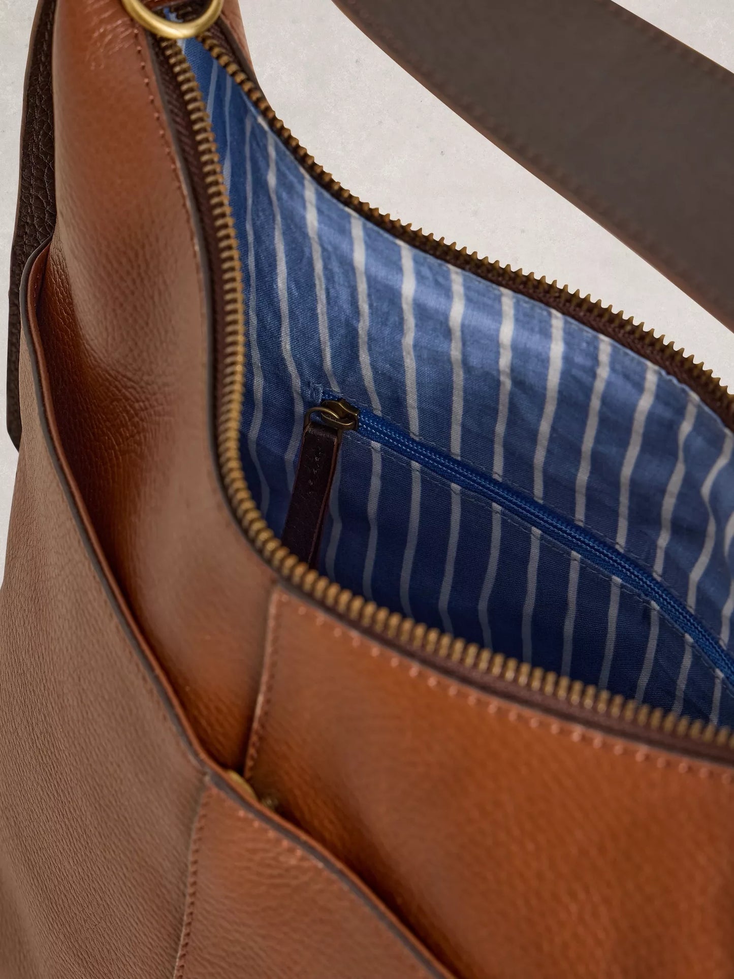 Brown leather bag with blue striped lining