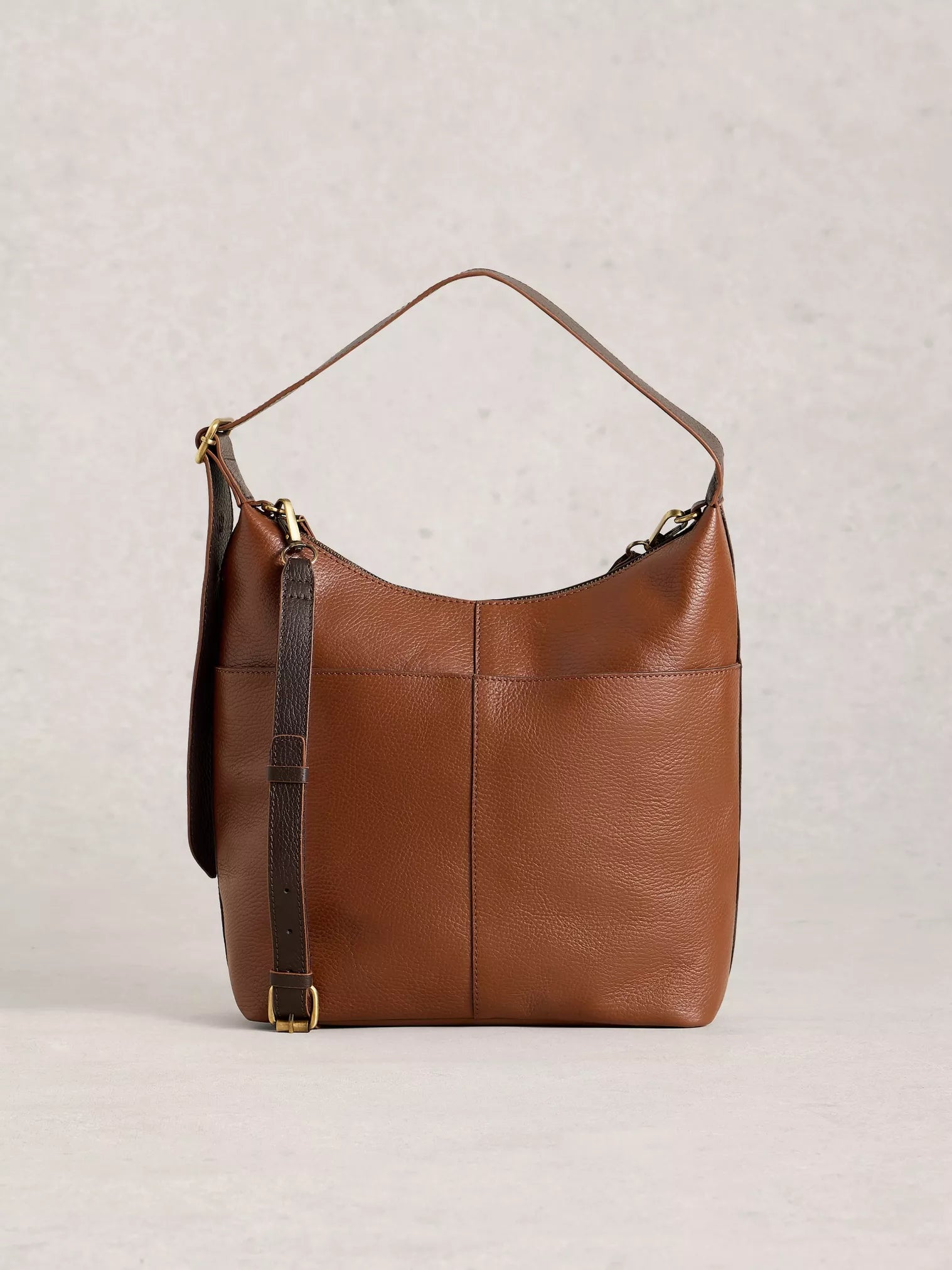 Brown leather handbag on a light gray background