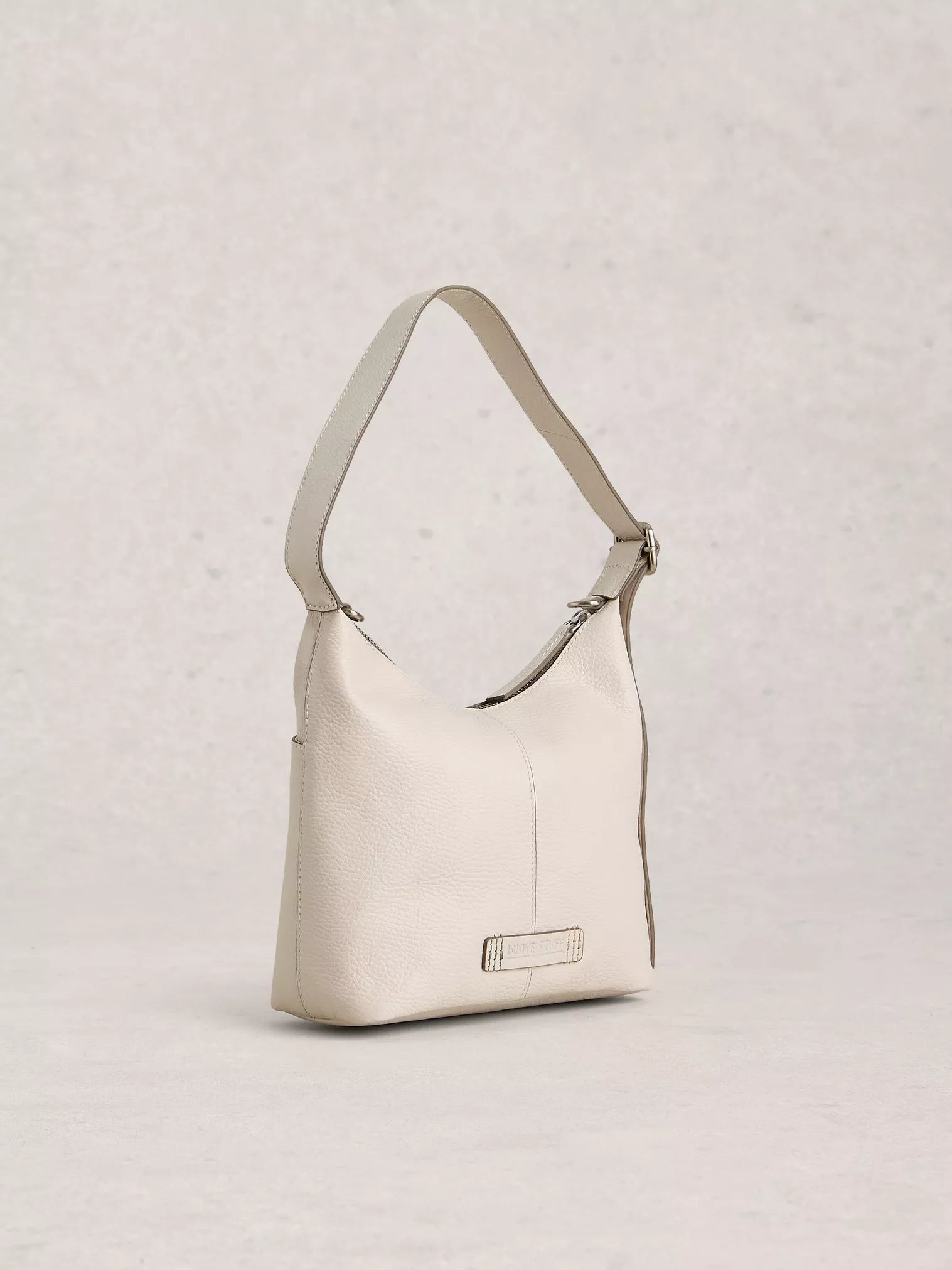 Beige shoulder bag on a light gray background