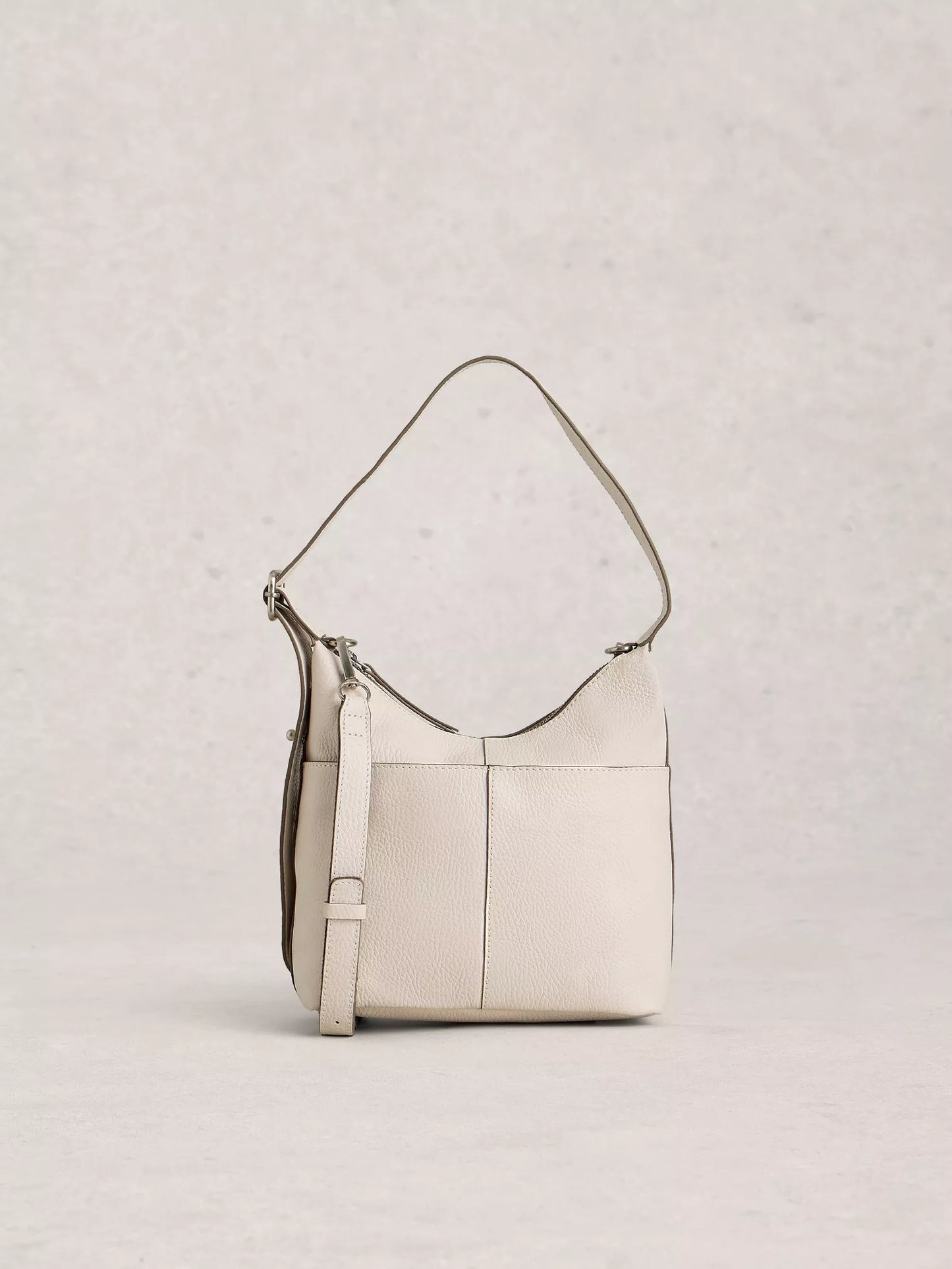 Beige handbag with a strap on a light gray background