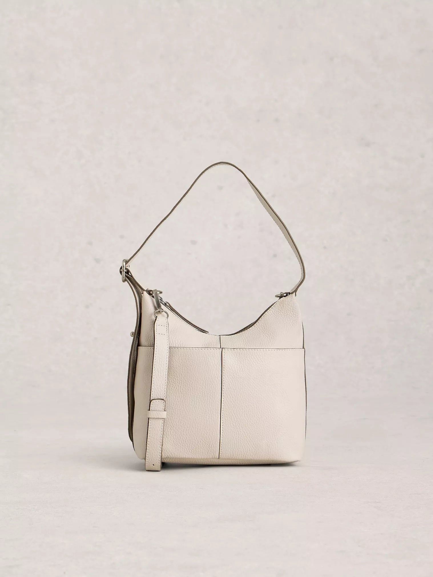 Beige handbag with a strap on a light gray background