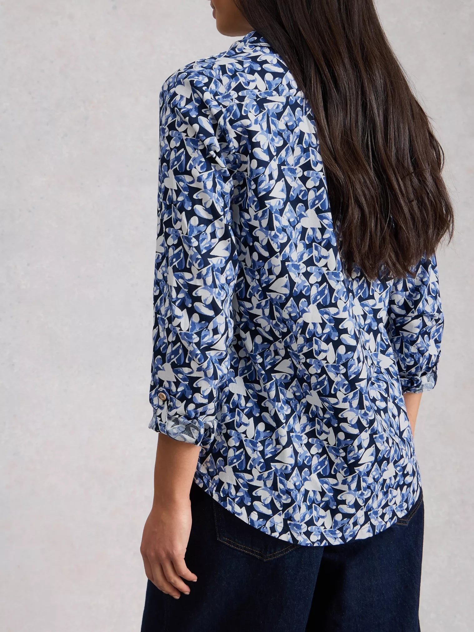 Back view of navy shirt with curved hem