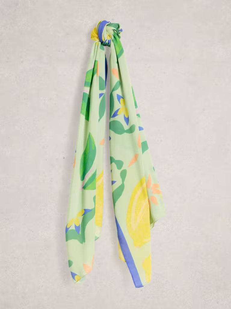 Colourful scarf with yellow floral pattern on a light grey background