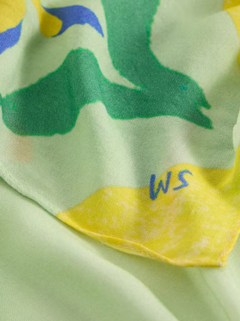 Close-up of a green and yellow scarf with White Stuff logo initials