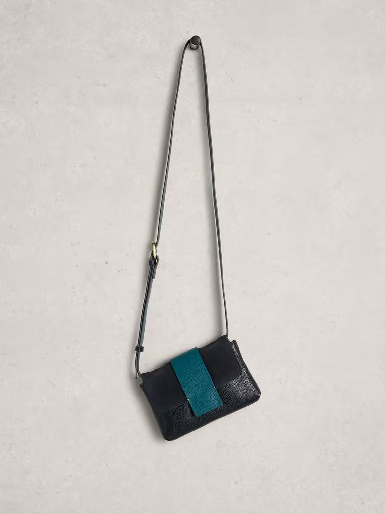 Navy crossbody bag with a blue stripe on a light grey background