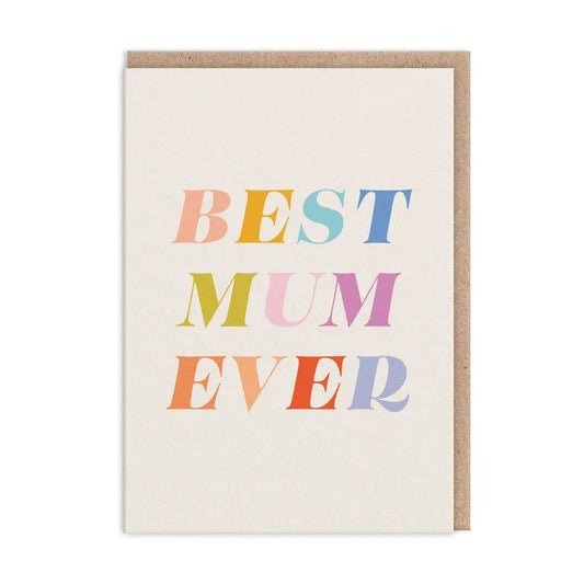 A greeting card with 'BEST MUM EVER' printed in multicolored letters on a beige background, accompanied by a brown envelope.