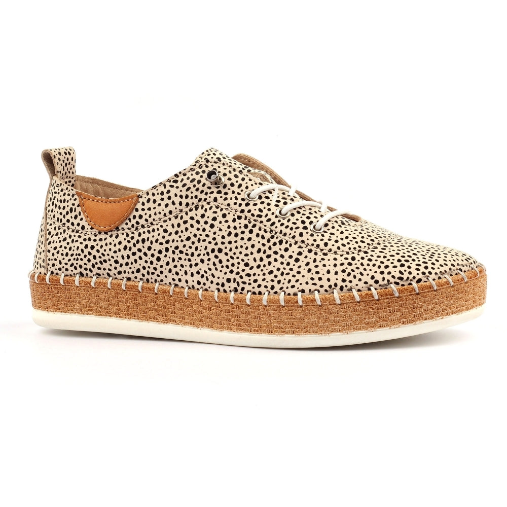 Sneaker with spotted pattern and brown sole on a white background