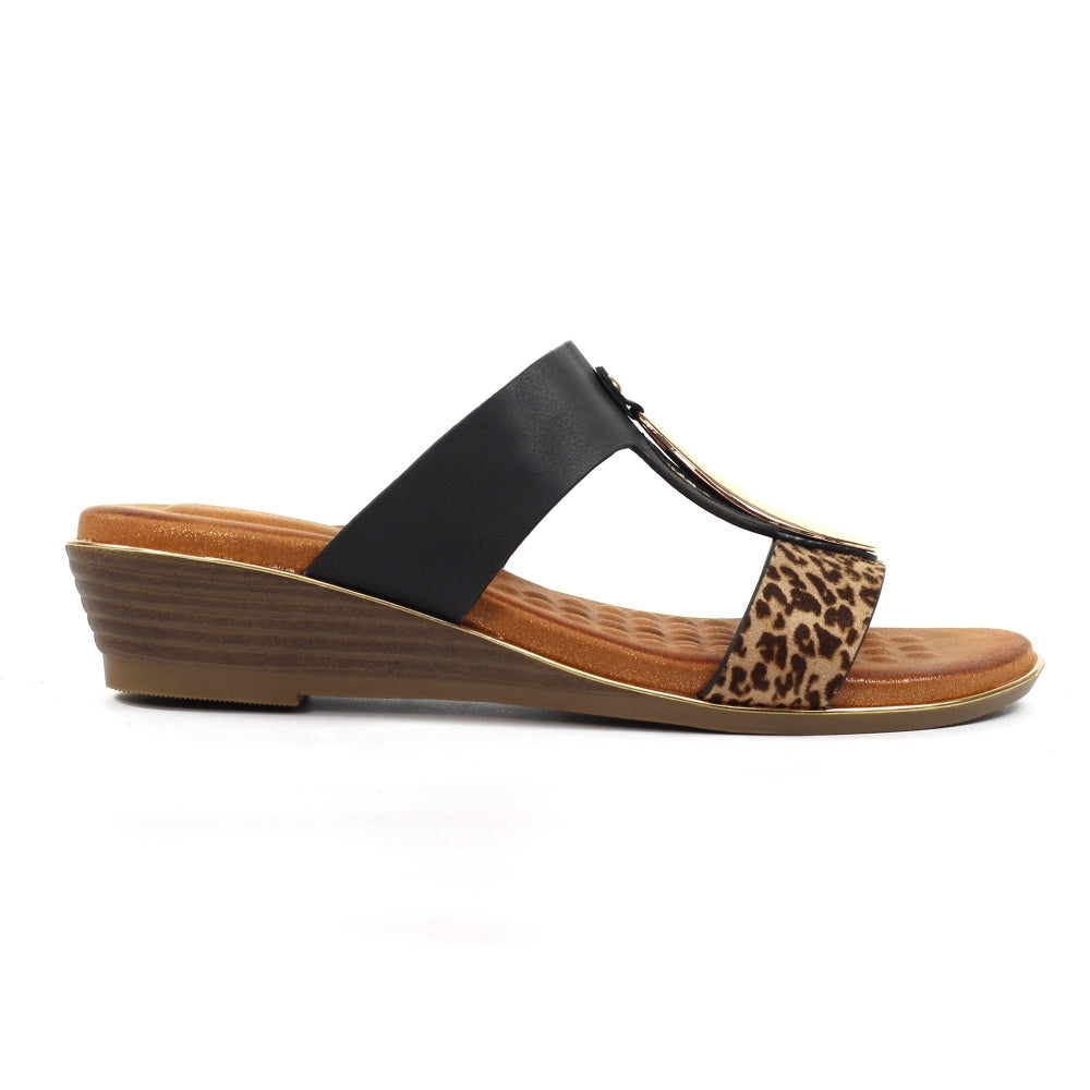 Wedge sandal with black strap and leopard print accent on a white background