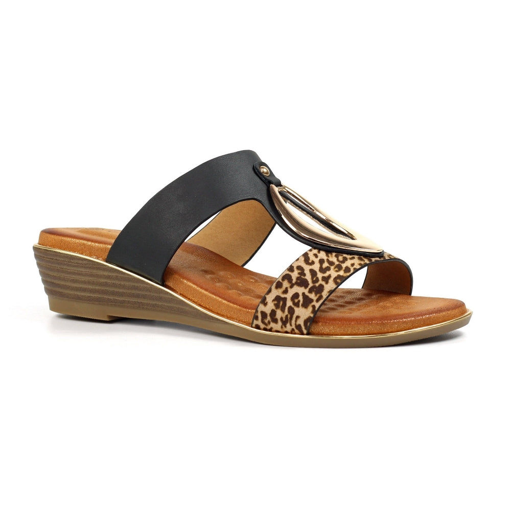 Wedge sandal with leopard print strap on a white background